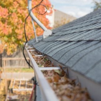 Stout Roofing crew performing roof repairs on damaged shingles and underlayment on a Utah home