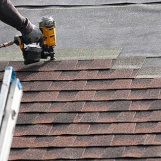 Stout roofing installing new shingles on roof.